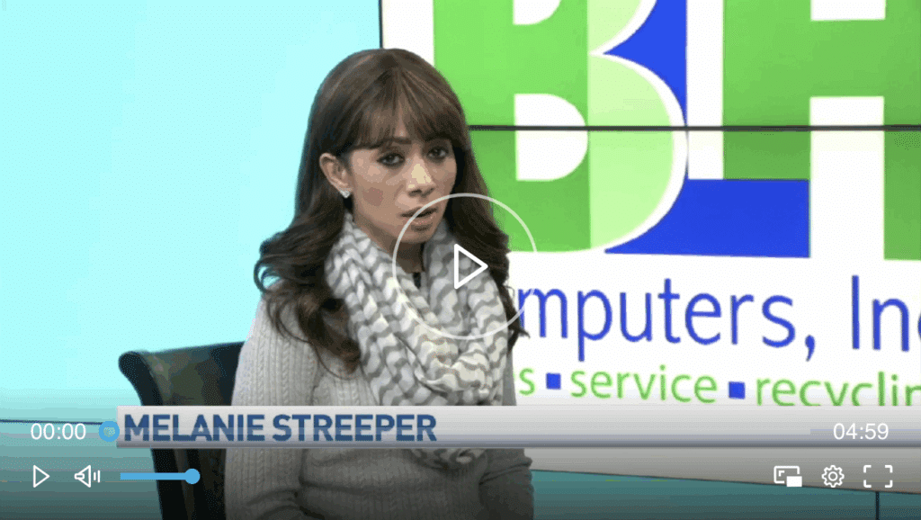 Employee standing in front of Computer Recycling Service logo